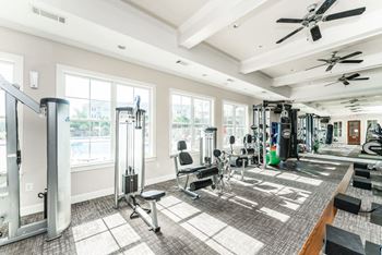 Premium fitness center with a variety of cardio and strength training equipment at Riverstone apartments